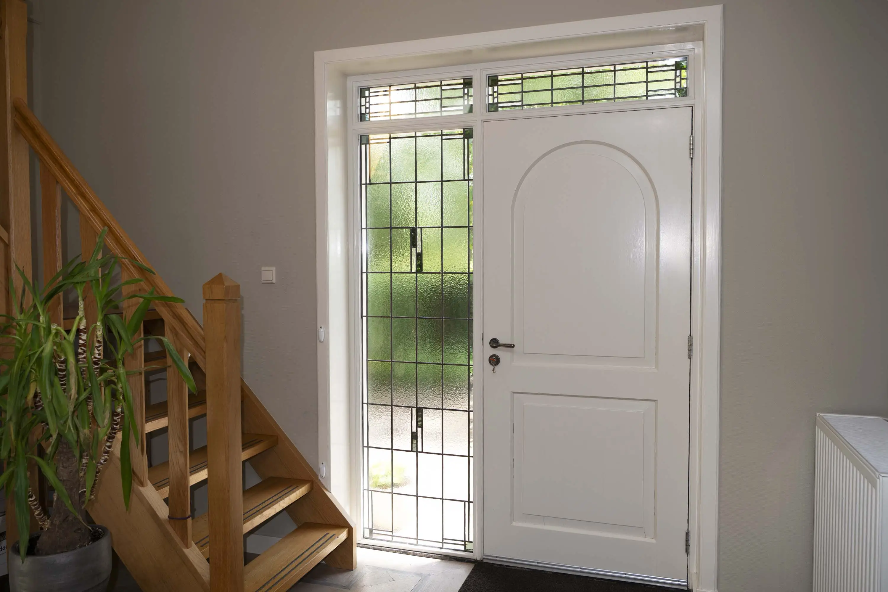 Scheffer Glas plaatste glas-in-lood rondom deze voordeur.